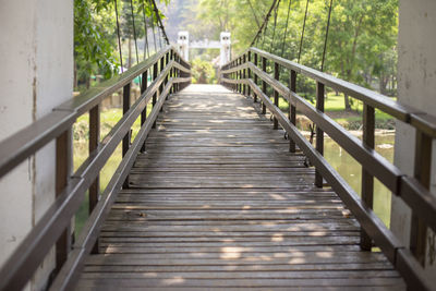 Wooden footbridge along trees