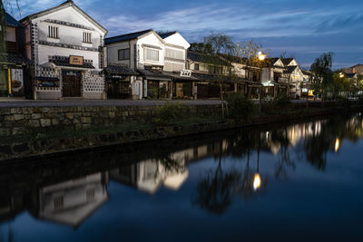 Reflection of buildings in lake against sky