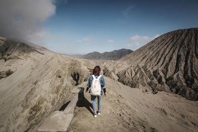 Man standing on mountain against sky