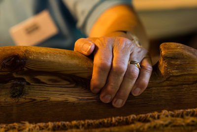 Midsection of man holding wooden plank