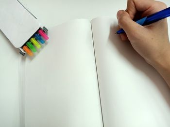 Midsection of person reading book on table