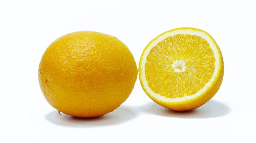 Close-up of oranges against white background