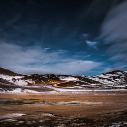 Scenic view of snowcapped mountains against sky at night