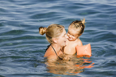 Mother and daughter in sea