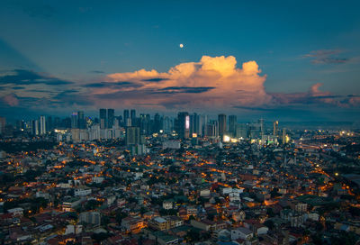 Aerial view of cityscape against sky during sunset