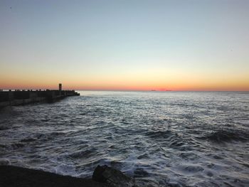 Scenic view of sea against clear sky during sunset