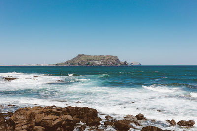 Scenic view of sea against clear blue sky