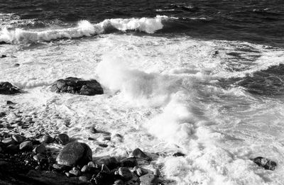 High angle view of waves splashing on shore