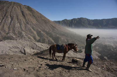 Friends on land against mountains