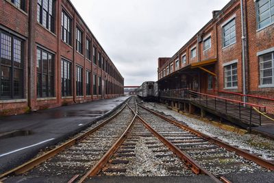 Railroad tracks against grey skies