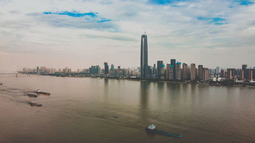 Scenic view of sea by buildings against sky