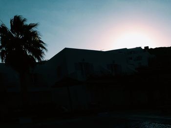 Buildings against sky at sunset