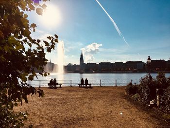 View of silhouette people on beach against sky