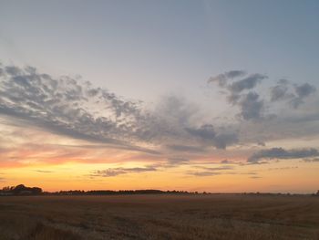 Scenic view of field against sky during sunset