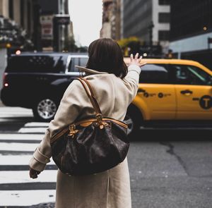 Rear view of a woman walking on road