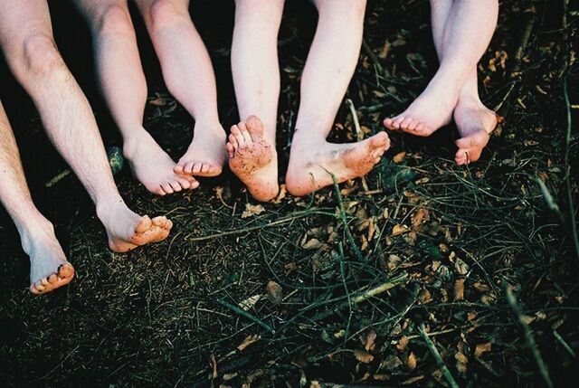 low section, person, lifestyles, human foot, leisure activity, men, shoe, togetherness, barefoot, standing, high angle view, part of, grass, footwear