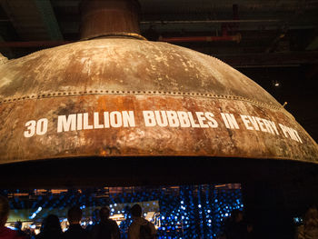 Low angle view of information sign at night