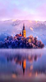 Reflection of building in lake at sunset
