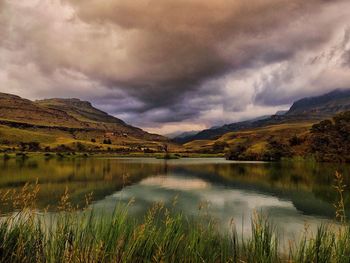 Scenic view of lake against cloudy sky