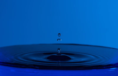 Close-up of water drop against blue background