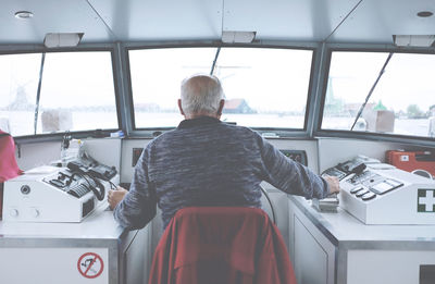 Rear view of man sitting in bus