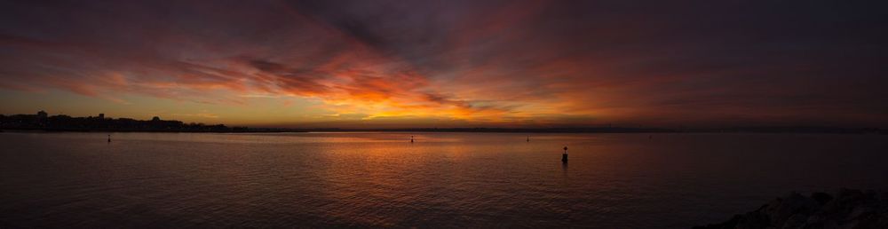 Scenic view of sea against romantic sky at sunset