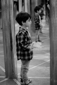 Rear view of child standing in front of man