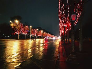 Illuminated street lights in city at night