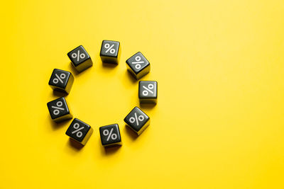 Close-up of dices on yellow background