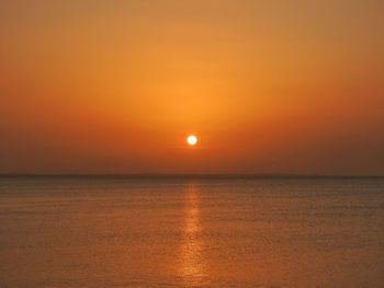 Scenic view of sea against orange sky