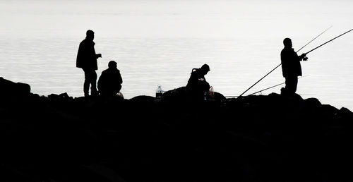 Silhouette people at beach