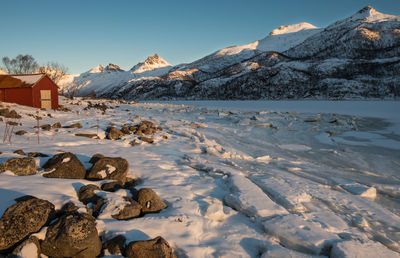 Scenic view of frozen lake against clear sky