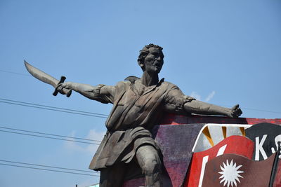 Low angle view of statue against clear blue sky