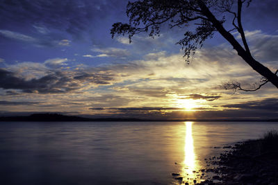 Reflection of clouds in sea at sunset