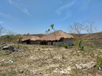 Abandoned house on field against sky