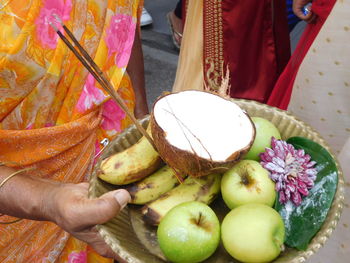 Midsection of man holding fruits