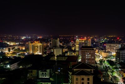 High angle view of illuminated buildings against clear sky at night