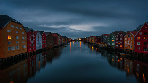 Panoramic view of river amidst buildings in city against sky