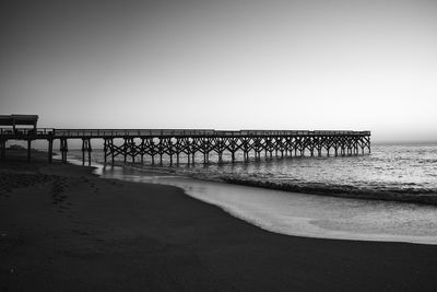 Pier over sea against clear sky