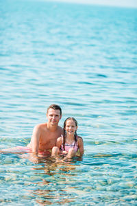 Portrait of young man swimming in pool