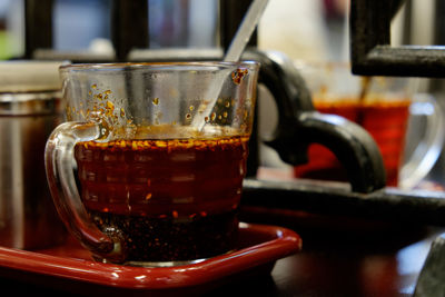 Close-up of coffee cup in tray on table