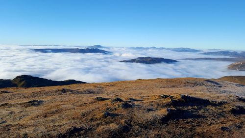 Scenic view of volcanic mountain against blue sky