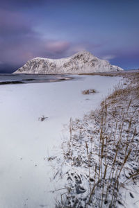 Scenic view of snowcapped mountains against sky during winter