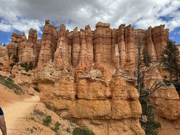 Low angle view of rock formations against sky