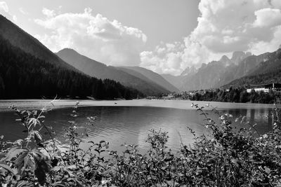 Scenic view of lake by mountains against sky