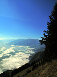 Scenic view of mountains against blue sky