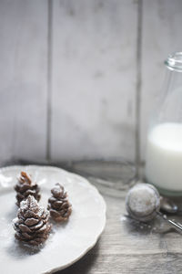 Pine cones in plate on table