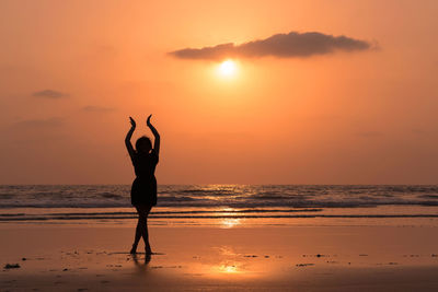 Silhouette of woman standing on beach