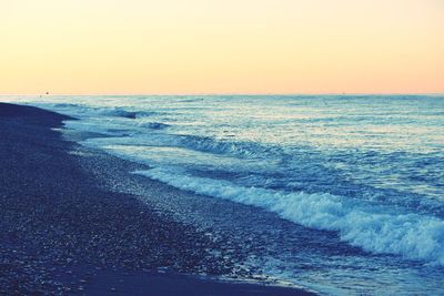 Scenic view of sea against clear sky at sunset