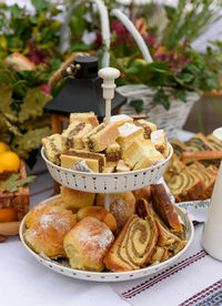 Mixed traditional home baked cakes on tray on table with autumn decorations